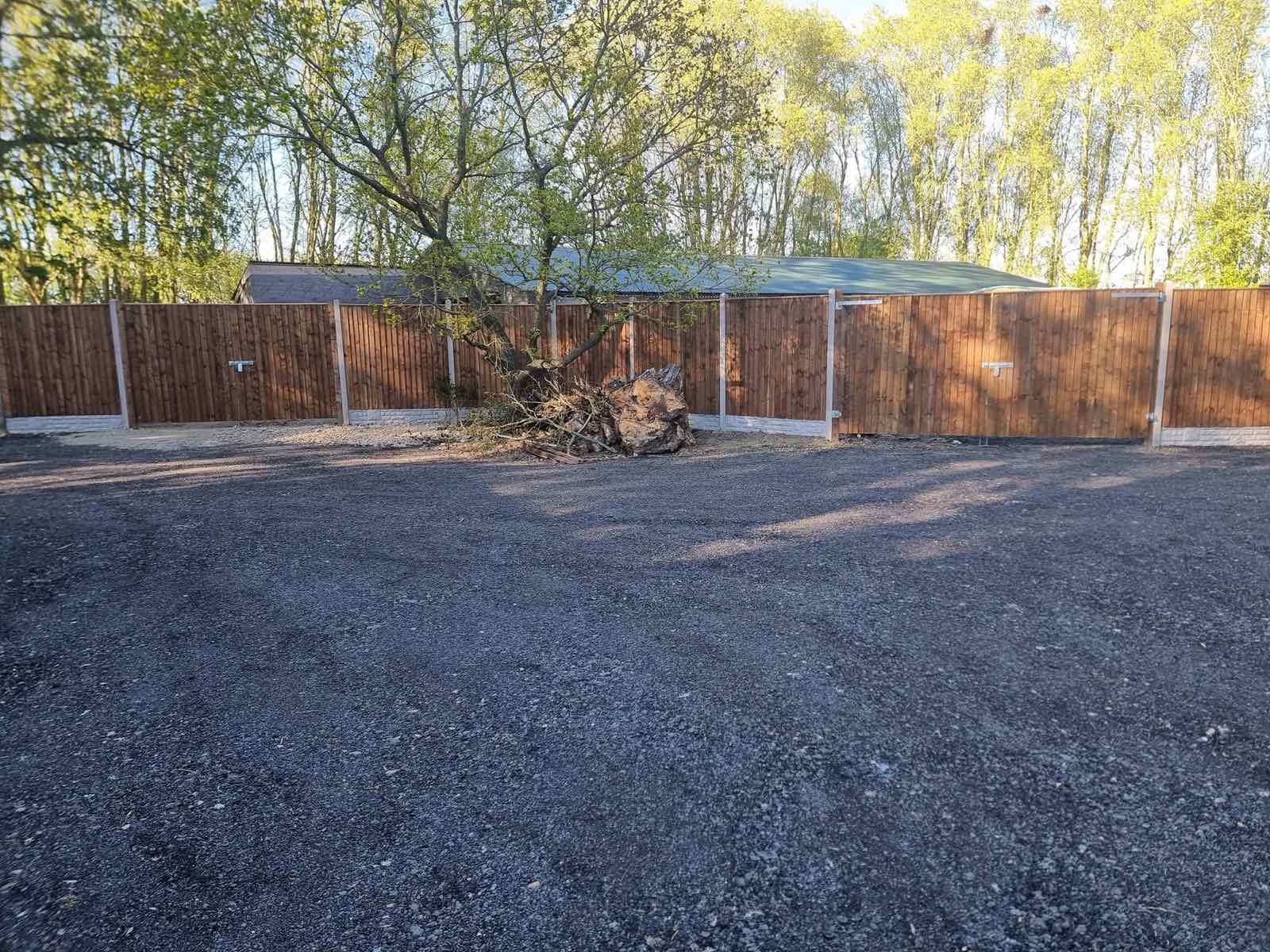 New close-board fencing around a resurfaced gravel driveway