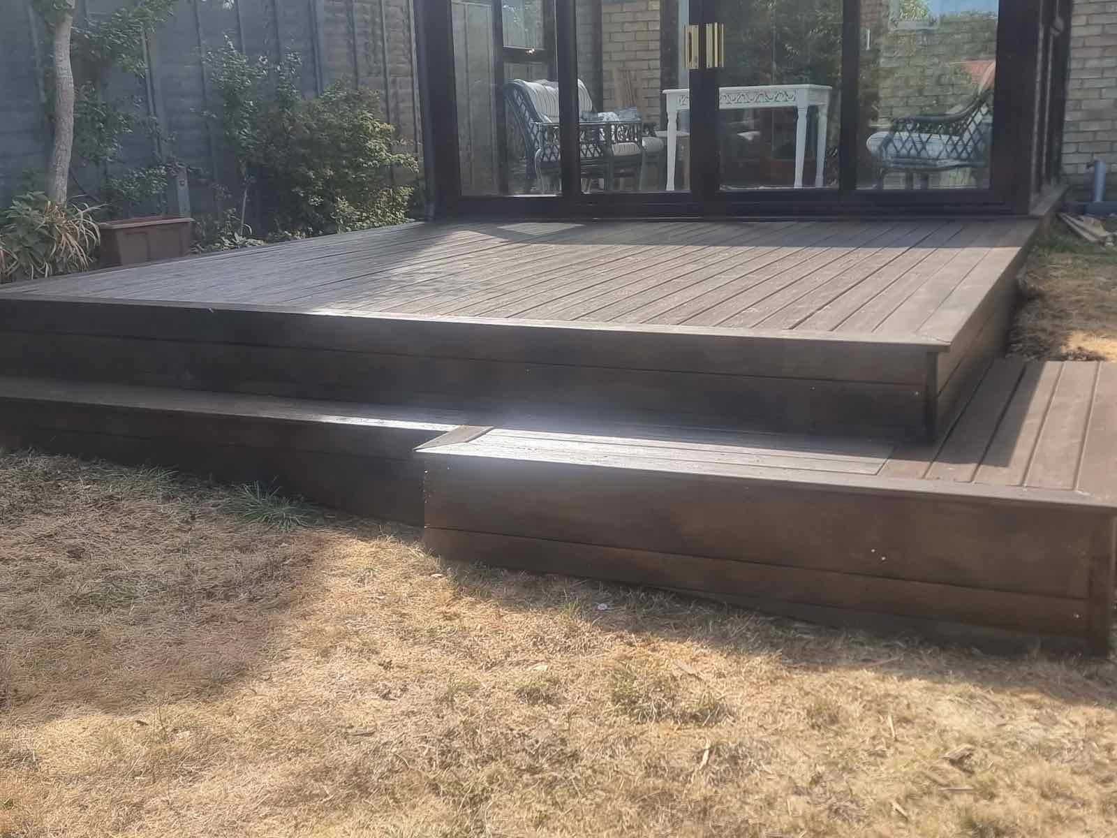 Finished composite decking with steps outside a garden room