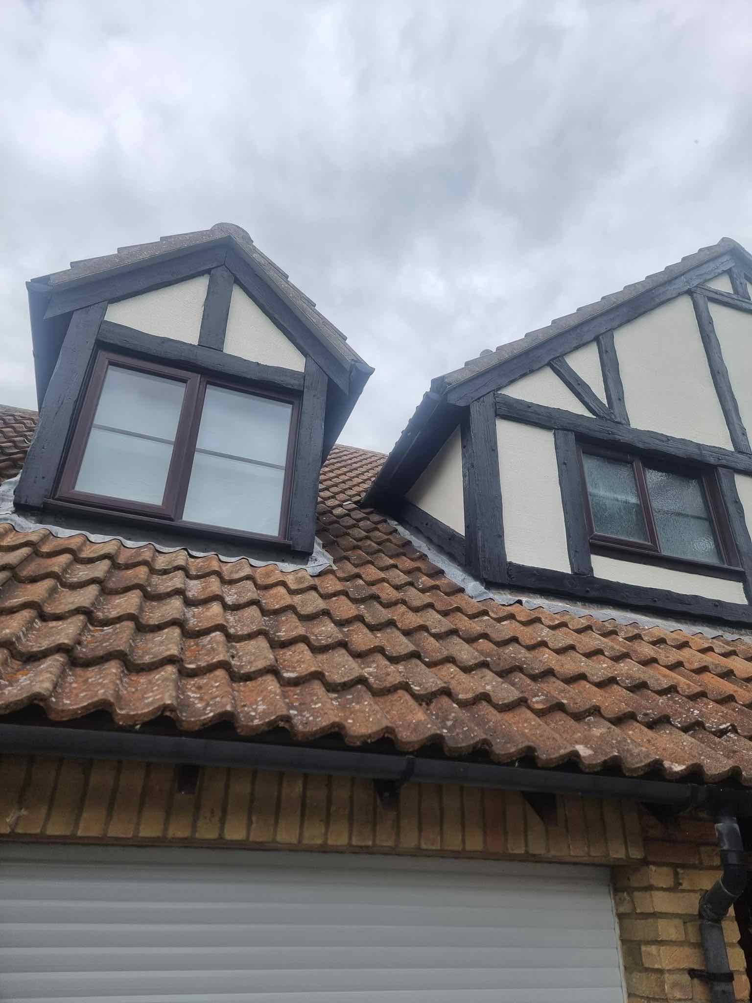 Finished render and mock-timber cladding repair on two roof dormers
