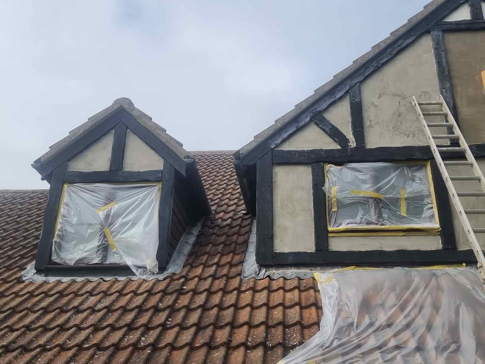 Roof dormer windows masked up during render and timber cladding repair