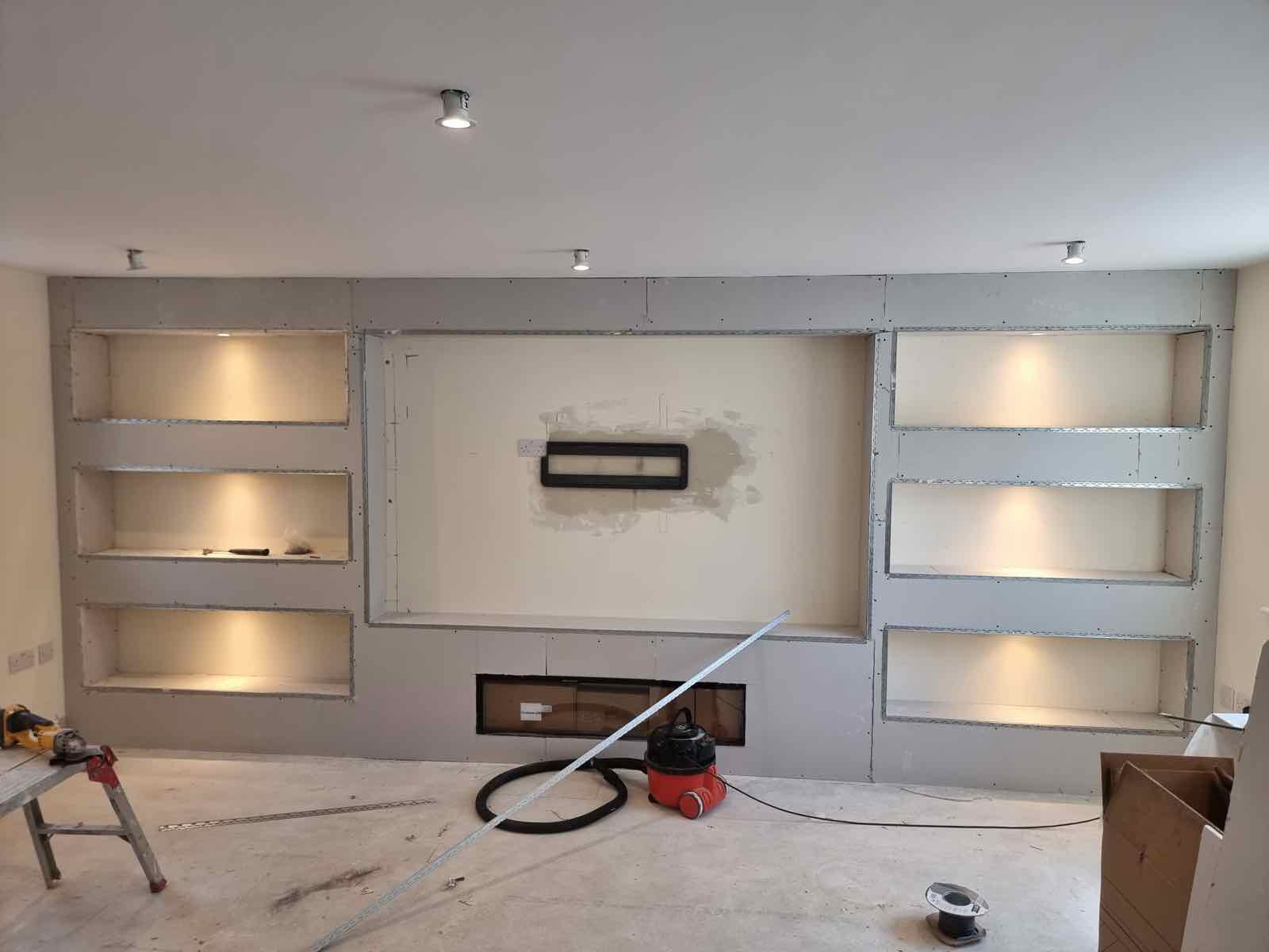 Stud-built alcove shelving and TV recess ready for plastering in a living room